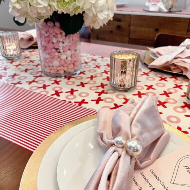 galentine's day table with place setting, menu, and flowers